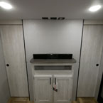 Entertainment Center with Two Privacy Doors on Either Side to Bedroom Shown Closed.
