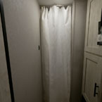 View into Bunk Room with White Privacy Curtain Shown Closed.
