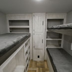 Bunk Room with Three Bunks- One on the Door Side with Storage Below, Two Bunks on the Off- Door Side. 
