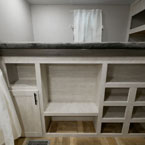 Bunk with Storage Below- One Cabinet Door with Ten Storage Compartments. 
