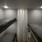 White Privacy Curtain in Bunk Room Shown Closed.
